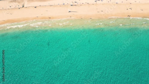 Summer seascape beautiful waves, blue sea water in sunny day. Esquinzo beach, Spain, Canary Island Top view from drone. Sea aerial view, tropical nature Beautiful bright sea waves photo