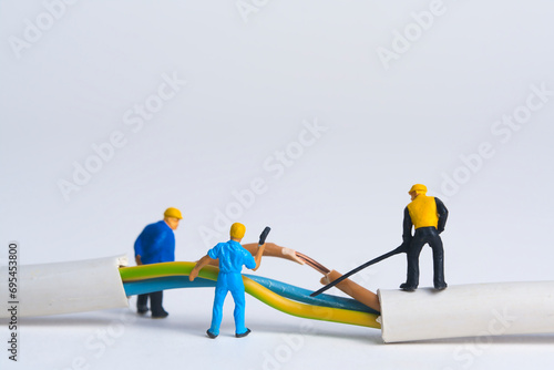 Repairing a broken power cable, miniature figures scene, white background