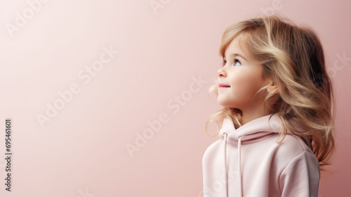 portrait of a beautiful cute little girl in profile, studio, pastel colors, stylish casual clothes, smiling child, kid, preschooler, emotional portrait, facial expression, background, space for text photo