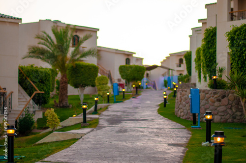 Walkway among bungalows with lanterns