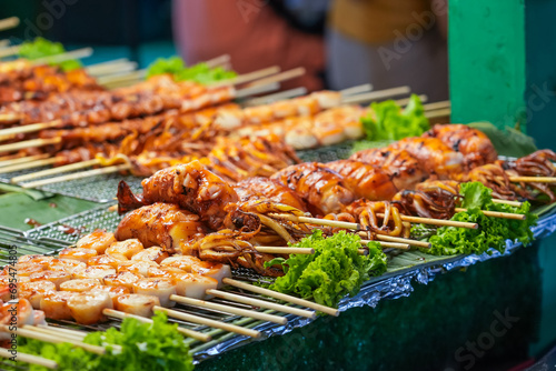 Seafood octopus and other meat balls on a street food stall. photo