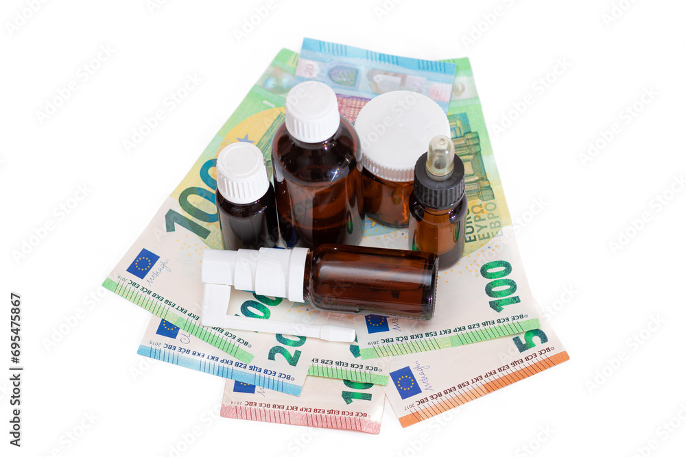 Different Bottles with Pills, Capsules and Medicines on the Euro Banknotes - Isolated on White. Global Pharmaceutical Industry and Big Pharma. Euro Money Bills - Isolation