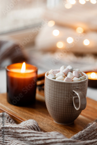 warm cozy window arrangement, winter or autumn concept, coffe, candles throw lights