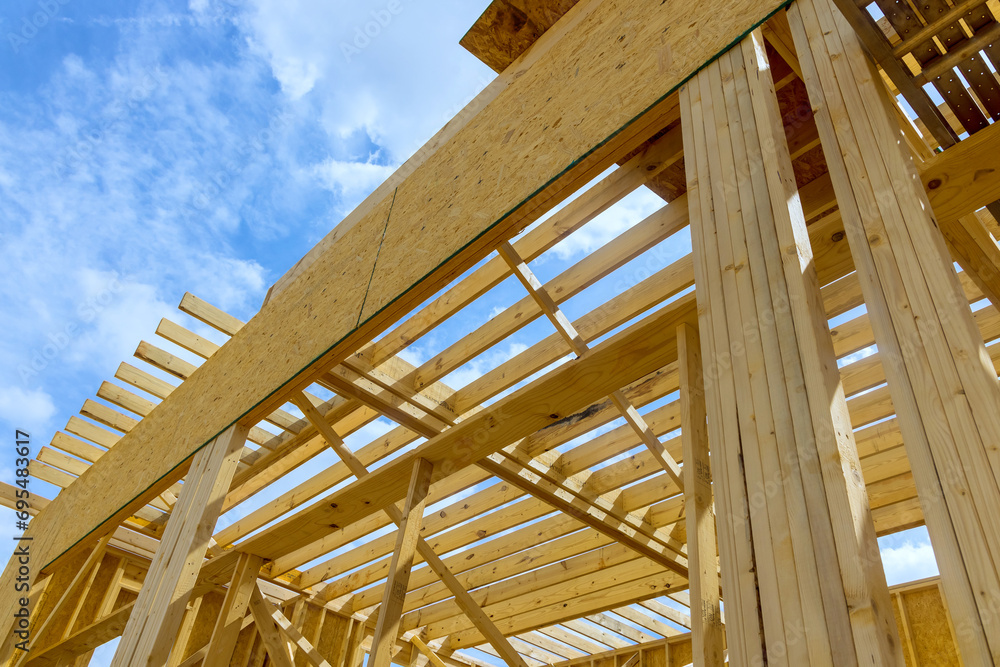 Beams framed in wooden framework under construction of new house Beams framed in wooden framework under construction of new house