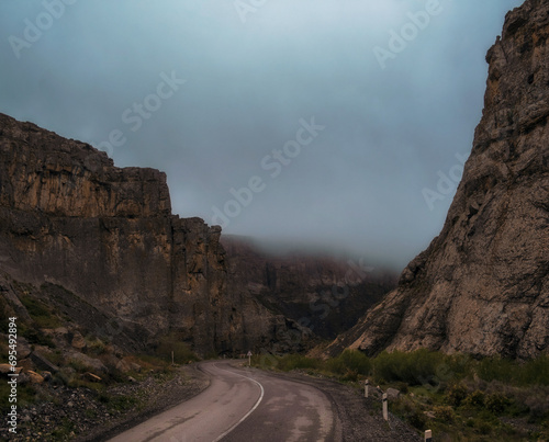 winding road in gloomy foggy rocky mountains. Pass in the Karatau mountains in Southern Kazakhstan