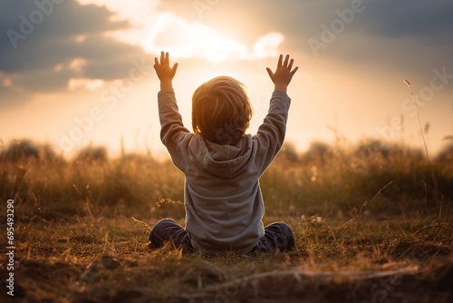In this realistic and professional photograph, capture the pure and heartfelt innocence of a child kneeling on a lawn, with hands raised to the sky in a reverent moment
