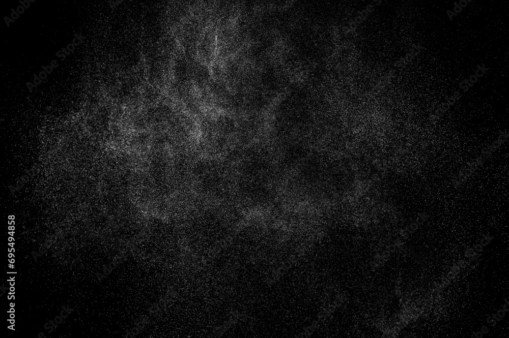 Abstract splashes of water on black background. Freeze motion of white particles. Rain, snow overlay texture.
Abstract splashes of water on black background. Freeze motion of white particles. Rain, snow overlay texture.