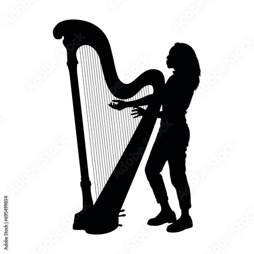 Young woman playing the harp silhouette. Female young harpist portrait silhouette.