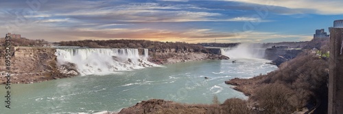 Panoramic picture over Niagara Falls with blue sky and rainbow in summer