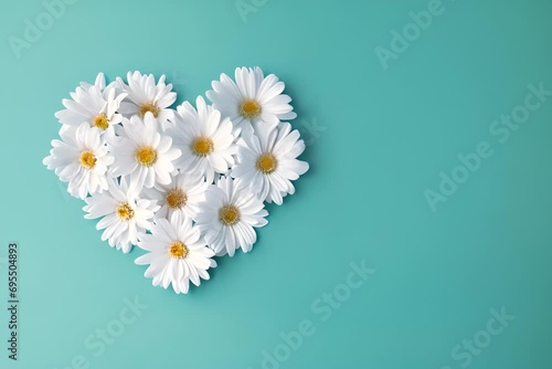 Moving daisies in shape of a heart on teal blue background. Heart and Daisy or Chamomile. Happy Mother's Day, Women's day, Charity Concept, With Copy Space. photo