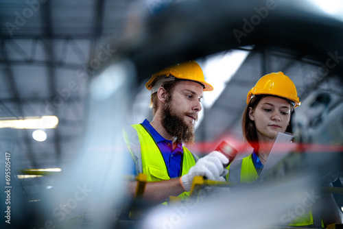 technician engineers team checking the machine and maintenance service. workers looking at the spare parts in the stock at the warehouse. labors with a checklist. photo