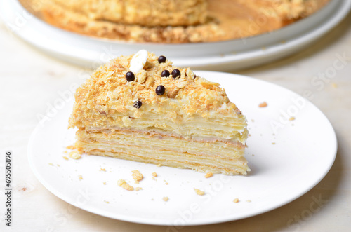 Delicious Napoleon Cake, Delicate Handmade Dessert with Custard and Puff Pastry Layers on Bright Background