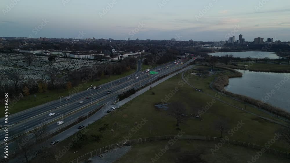 cars driving north and south on the van wyck expressway in queens, new york city (shot from corona flushing meadows park with meadow and willow lake in view) still drone footage from above flying cars driving north and south on the van wyck expressway in queens, new york city (shot from corona flushing meadows park with meadow and willow lake in view) still drone footage from above flying