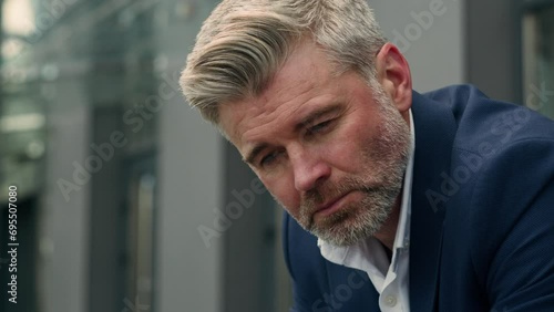 Mature worried anxiety Caucasian sad upset business man stressed depressed businessman thinking problem solution think trouble headache pain migraine stress hopeless despair employer in city outdoors photo