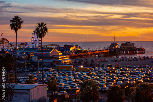 The beachfront parking lot in Santa Monica, california during sunset. Picture taken from the bluffs with the santa monica pier in the background. photo