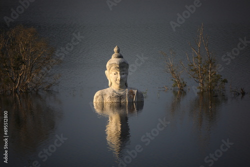 Sinking Buddha statue (Drowning Buddha) and reflection.A large Buddha statue in the middle of the lake. Phre Phutta Siri Phuwadon Mongkolchai.
Khao Ra-Kham reservoir, Trat province,Thailand. photo