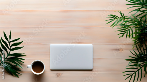 closed laptop and a cup of coffee on a wooden table