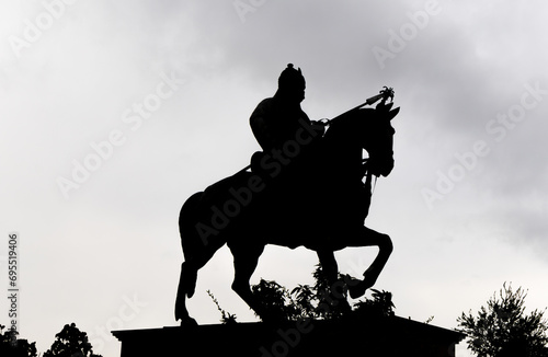 backlit shot of indian warrior maharana pratap statue at day from unique perspective photo