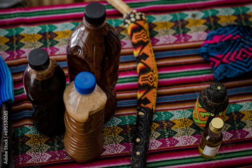 Sao Paulo, SP, Brazil - December 16 2023: Ceremony altar, bottle with Ayahuasca, bone tepi for applying snuff.