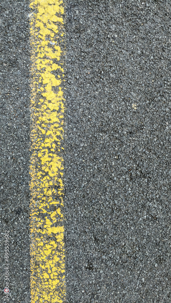 Fototapeta premium Yellow lines on asphalt