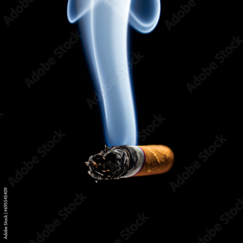 Burning Smoking Cigarette on Black Background photo