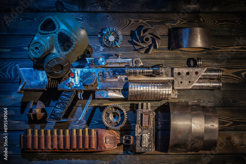Sci fi post apocalypse pump shotgun and gas mask on the survivor table concept background. photo