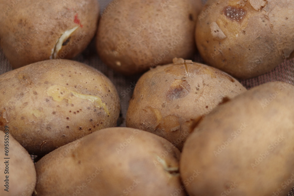 Shot of bunch of Indian Brown boiled potatoes in a net Basket or plate, closeup Shot of bunch of Indian Brown boiled potatoes in a net Basket or plate, closeup