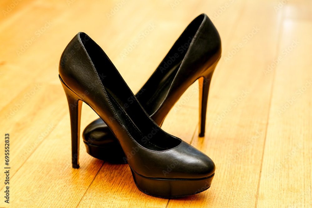 Elegant black high heel platform stilettos on natural wooden floor, high heel leather platform shoes Elegant black high heel platform stilettos on natural wooden floor, high heel leather platform shoes