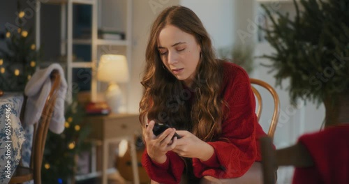 Sad woman with smart phone at home