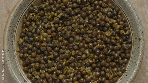 Top view of Methi Kerau. Fenugreek seeds with dried green peas in clay bowl. Authentic Newari dish. Seamless loop. photo
