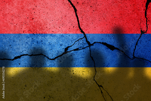 Armenia and Azerbaijan conflict in Nagorno Karabakh. Armenian flag on the cracked concrete wall with protesters photo