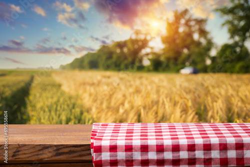 wood board table in front of field of wheat on sunset light. Ready for product display montage. High quality photo