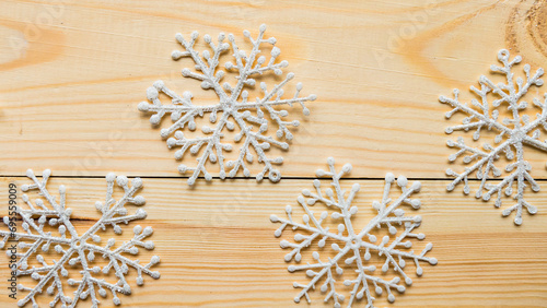 White snowflakes on wooden background. Merry Christmas concept
