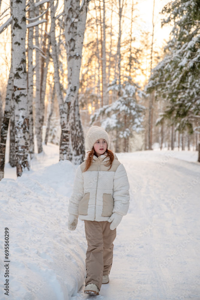 Cute little girl in winter walks in winter snow-covered forest. Winter Activities, Pastime, Walk Cute little girl in winter walks in winter snow-covered forest. Winter Activities, Pastime, Walk