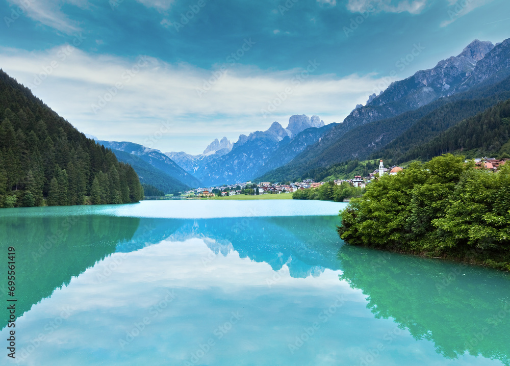 Tranquil summer Italian dolomites mountain lake and village view (Auronzo di Cadore)