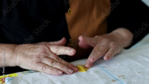Woman's hands preparing the traditional fresh Italian pasta Cappelletti. Homemade pasta production process. Conceptual of typical Italian Christmas family cooking. Chef at work Romagna Bologna photo