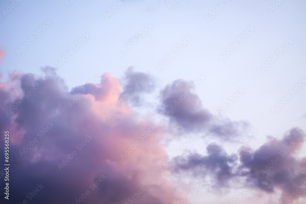 Bright sunset sky with gentle colorful clouds.