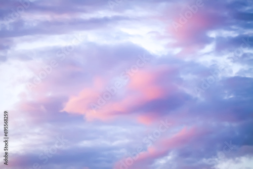 Bright sunset sky with gentle colorful clouds.