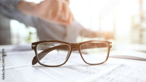 office desk with glasses and financial report photo