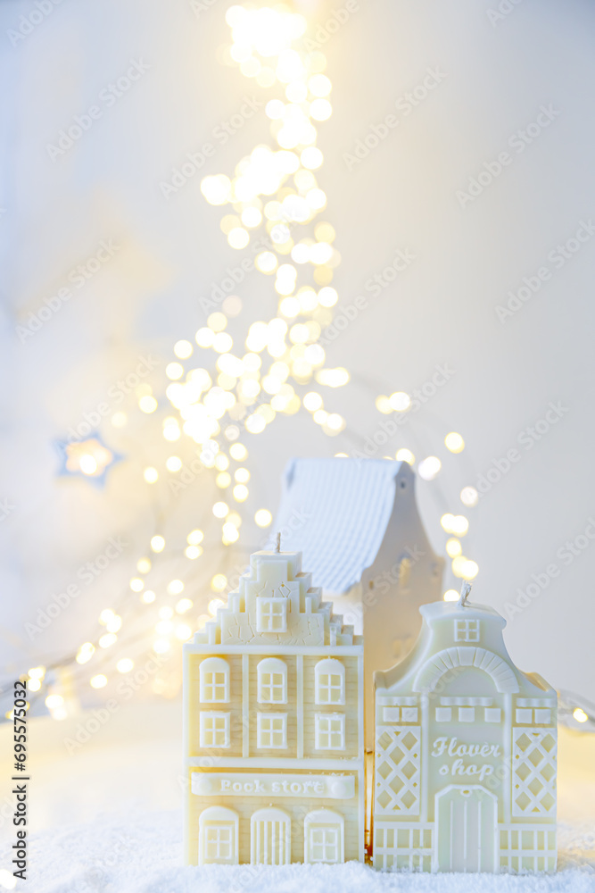 Christmas scandinavian houses ornament. Space for text. Christmas winter still life. Natural Christmas decorations for home. Vertical. Snow flakes. Candle and burning warm lights. White miracle. Fairy Christmas scandinavian houses ornament. Space for text. Christmas winter still life. Natural Christmas decorations for home. Vertical. Snow flakes. Candle and burning warm lights. White miracle. Fairy