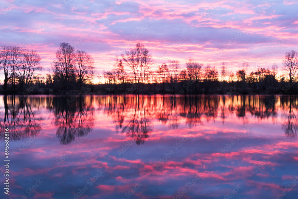 Nightscape at Adour French river in blazing red sunset. Photography taken in France