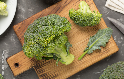 Fresh tasty broccoli on concrete background, top view
