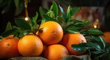 ripe oranges are sitting next to a christmas tree