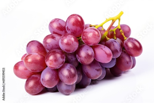  a bunch of grapes sitting on top of each other on top of a white surface with a yellow stem sticking out of the top of the bunch of the grapes.