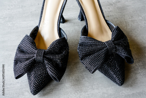 Black heeled sexy backless slip-on mules with a bow and glitters, pleasure shoes photo