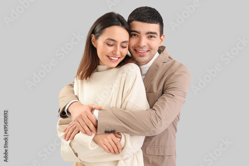 Happy young couple embracin...
