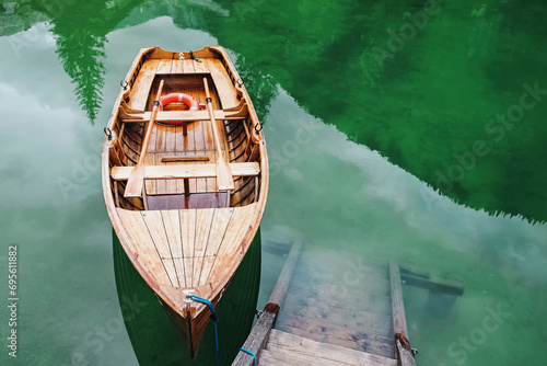 Wooden boat with no people on Lago di Braies, Italy. photo