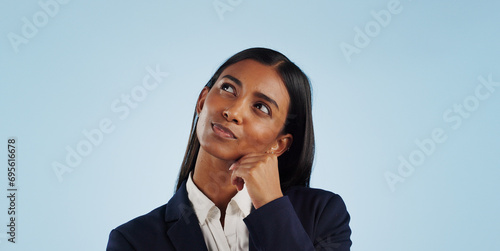 Thinking, studio or businesswoman on blue background for problem solving, vision or solution. Idea, doubt or decision with a female attorney or lawyer contemplating a thought, choice or legal option photo