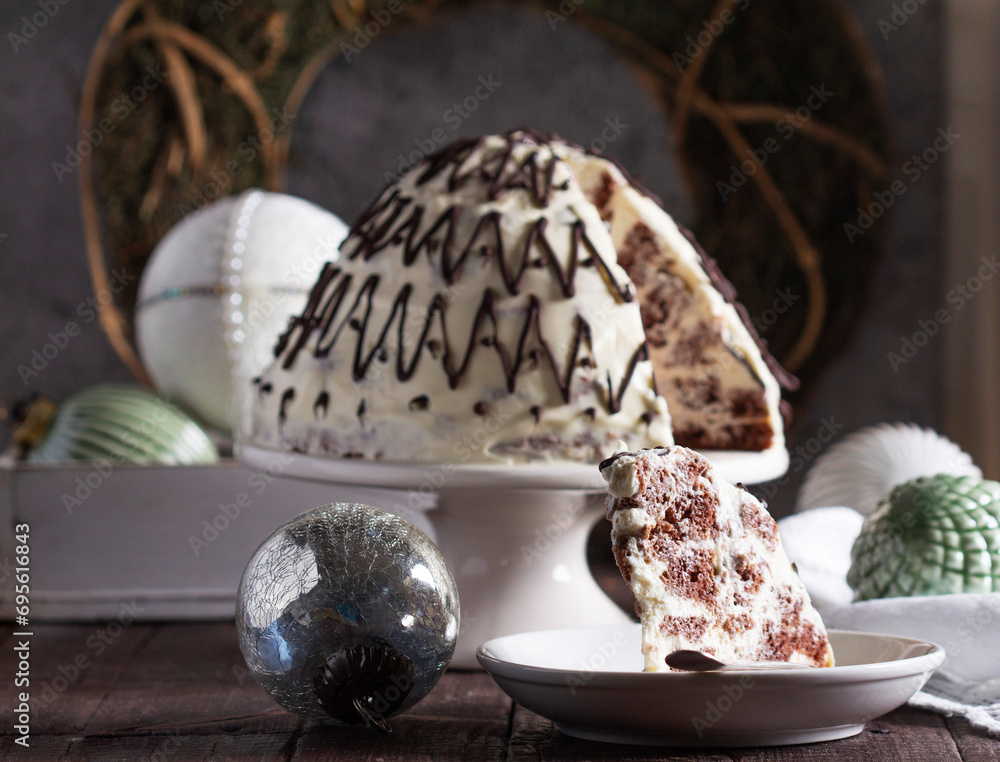 Pancho cake made of chocolate biscuit with sour cream and pineapple in New Year's or Christmas decoration. Rustic style.