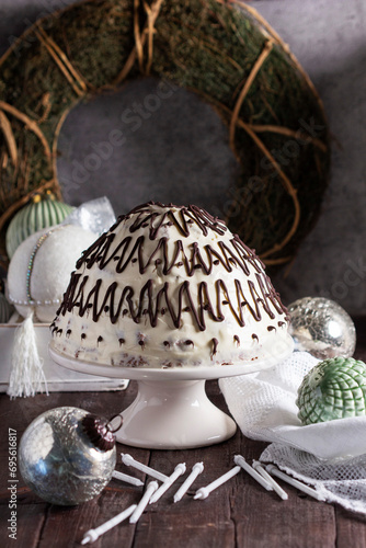 Pancho cake made of chocolate biscuit with sour cream and pineapple in New Year's or Christmas decoration. Rustic style.
